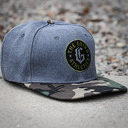The Grind Athletics Camo and Gray "G" Snapback Hat