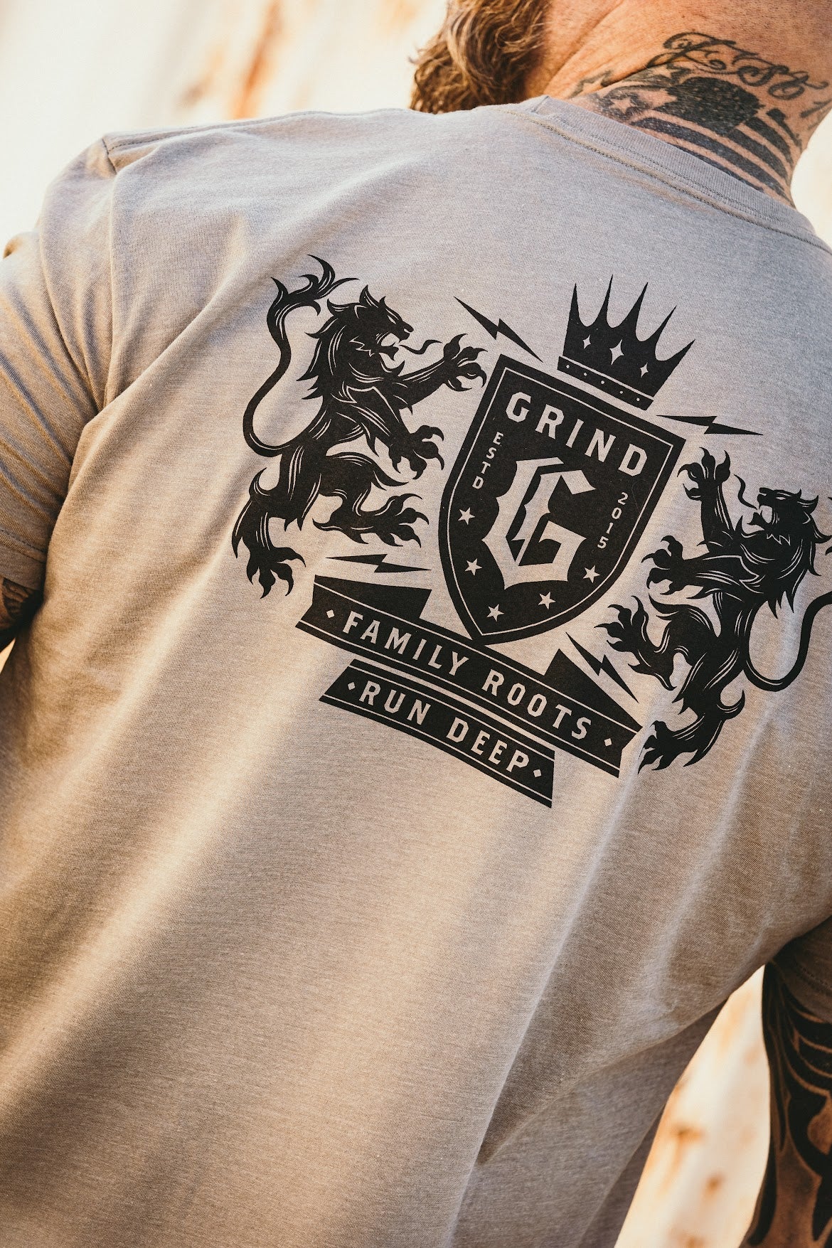 The Grind Athletics S / Stone Gray Family Crest- T